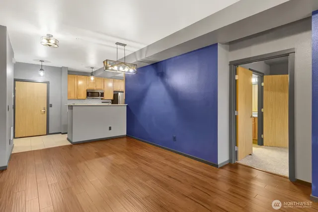 a view of a kitchen with a sink and cabinet area with wooden floor
