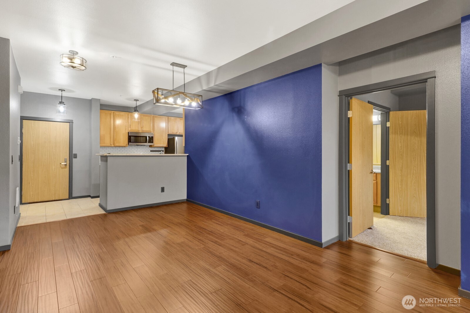 516 Darby Drive, Unit 104 Bellingham, WA 98226 - Photo 23 of 40 a view of a kitchen with a sink and cabinet area with wooden floor