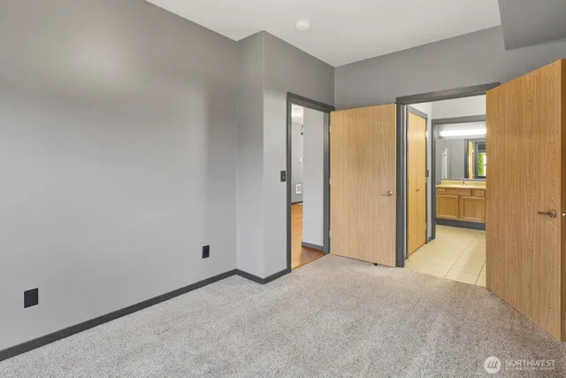 an empty room with closet and a bathroom