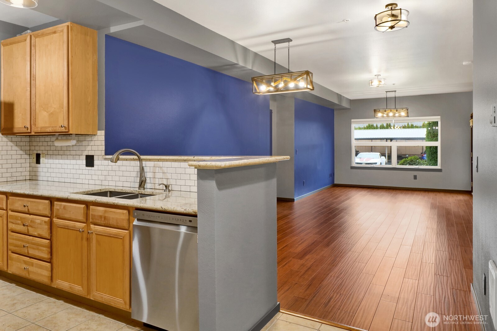 516 Darby Drive, Unit 104 Bellingham, WA 98226 - Photo 31 of 40 a kitchen with stainless steel appliances granite countertop a sink a stove a refrigerator cabinets and wooden floor