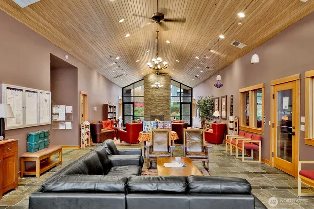 a living room with fireplace furniture and a large window