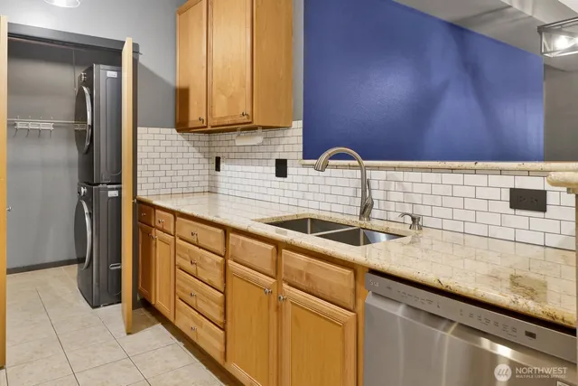 a kitchen with stainless steel appliances granite countertop a sink and cabinets