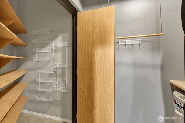 a view of walk in closet with empty racks