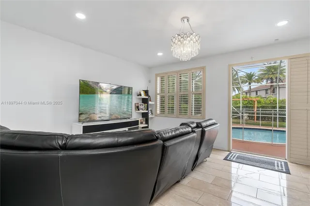 a living room with granite countertop furniture and a chandelier