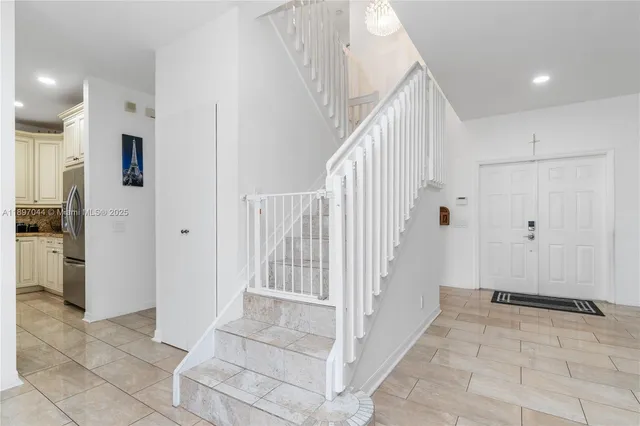 a view of entryway with kitchen and hallway