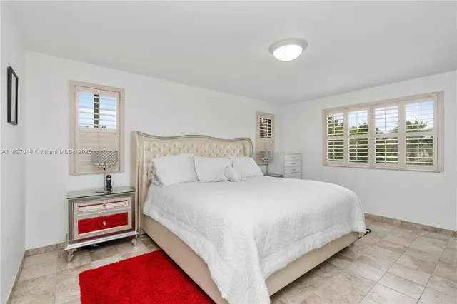 a bedroom with bed and a window