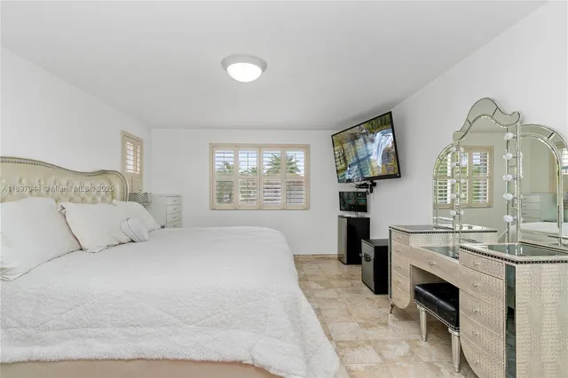 a large white bed in a white room