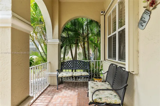 a balcony with furniture and a potted plant
