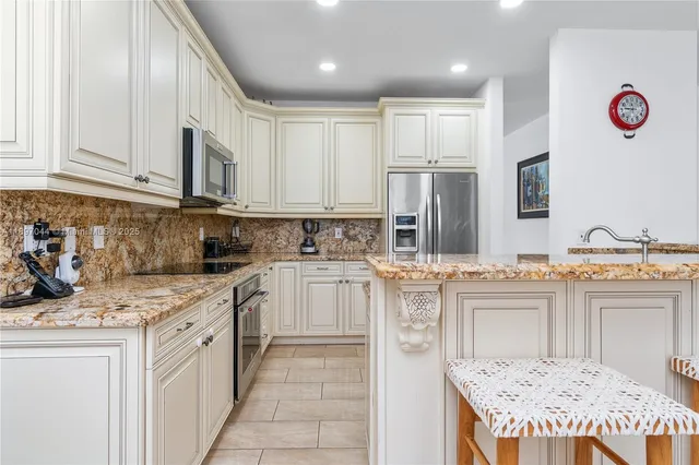 a kitchen with stainless steel appliances granite countertop a sink and cabinets