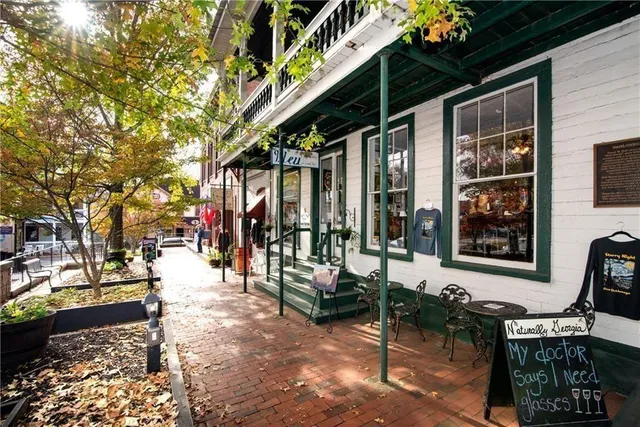 a view of a hallway with a table and chairs