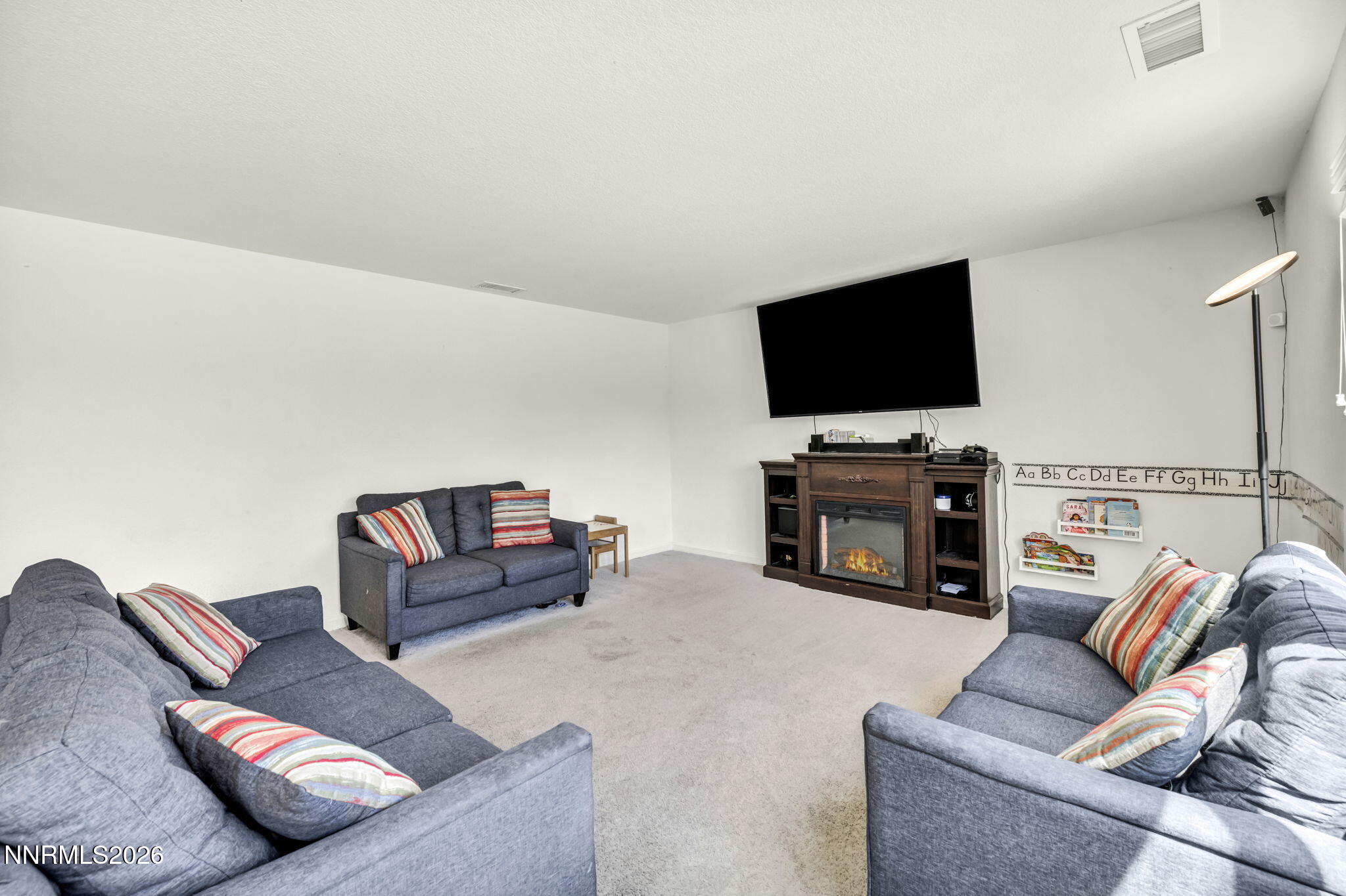 8982 Wolf River Drive Reno, NV 89506 - Photo 14 of 65 a living room with furniture and a flat screen tv