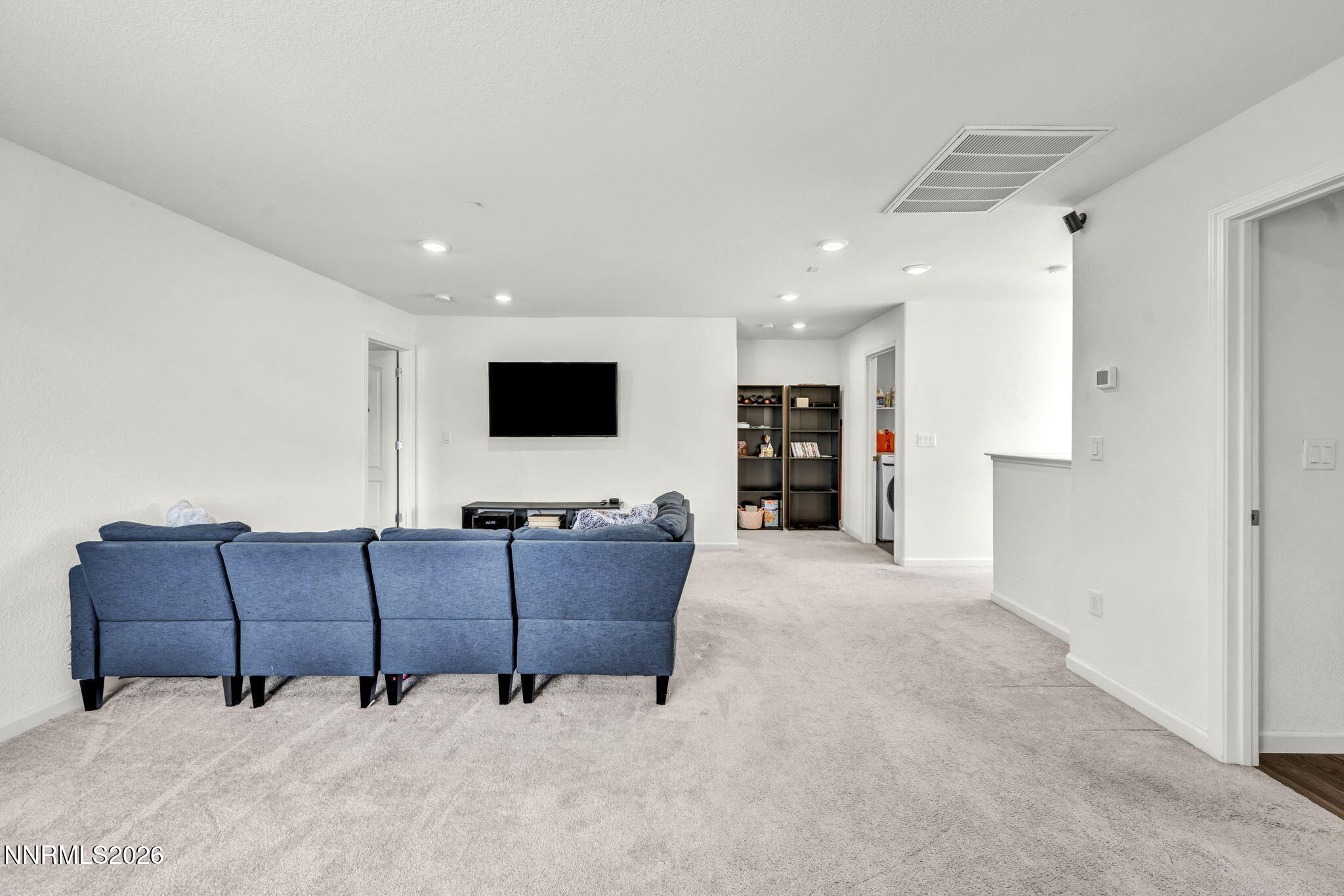 8982 Wolf River Drive Reno, NV 89506 - Photo 28 of 65 a living room with couches and a flat screen tv