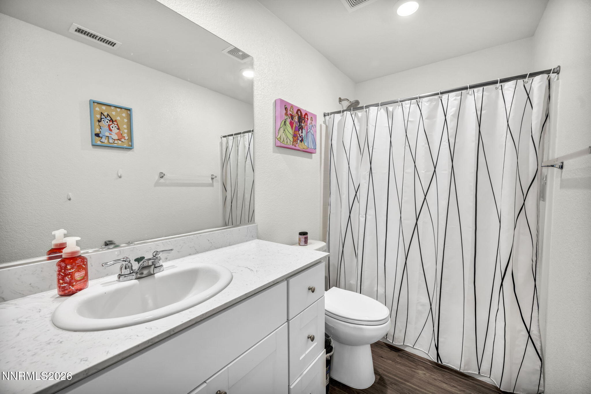 8982 Wolf River Drive Reno, NV 89506 - Photo 31 of 65 a bathroom with a sink a toilet and a mirror