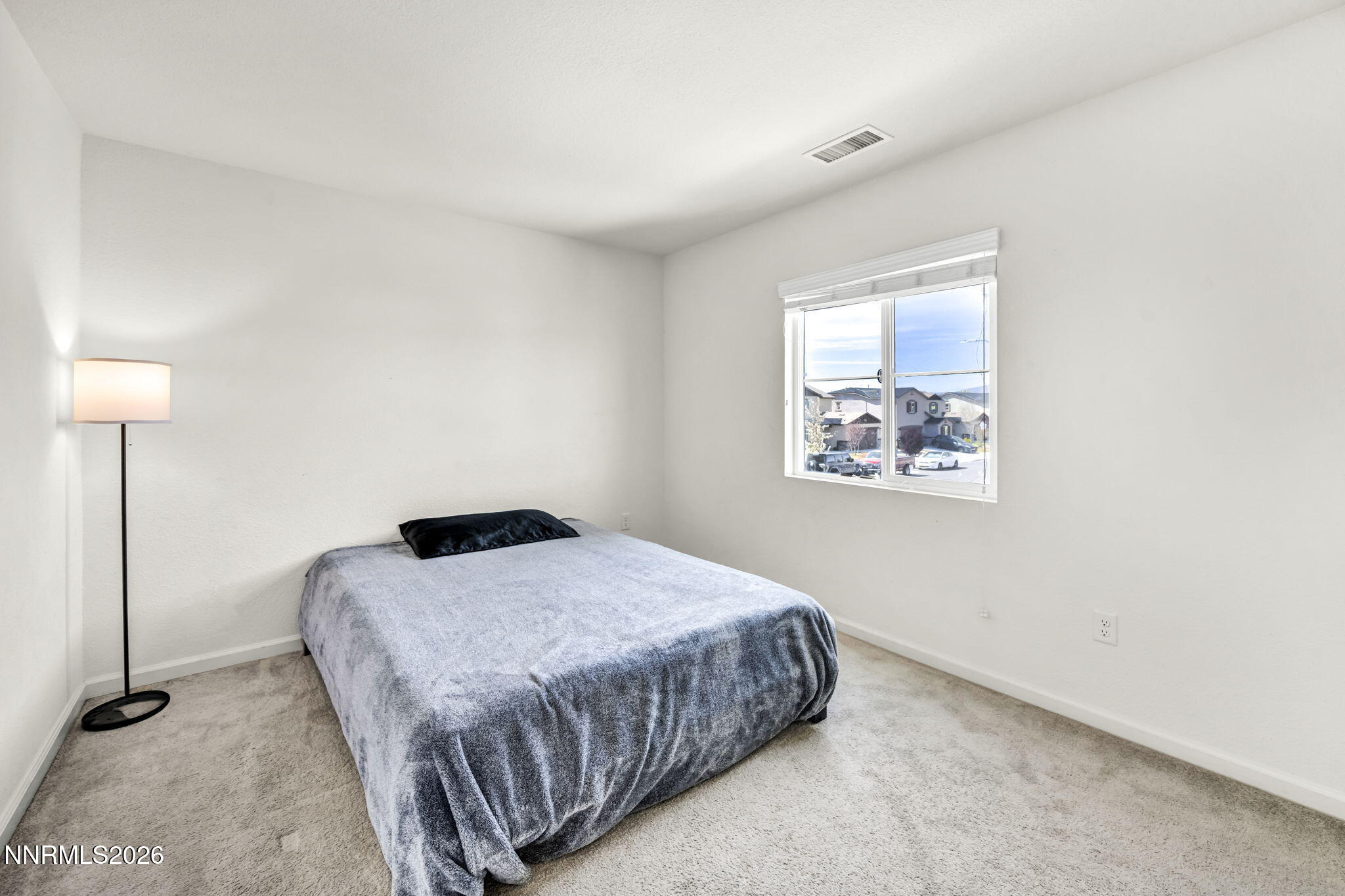 8982 Wolf River Drive Reno, NV 89506 - Photo 32 of 65 a bedroom with a bed and a window