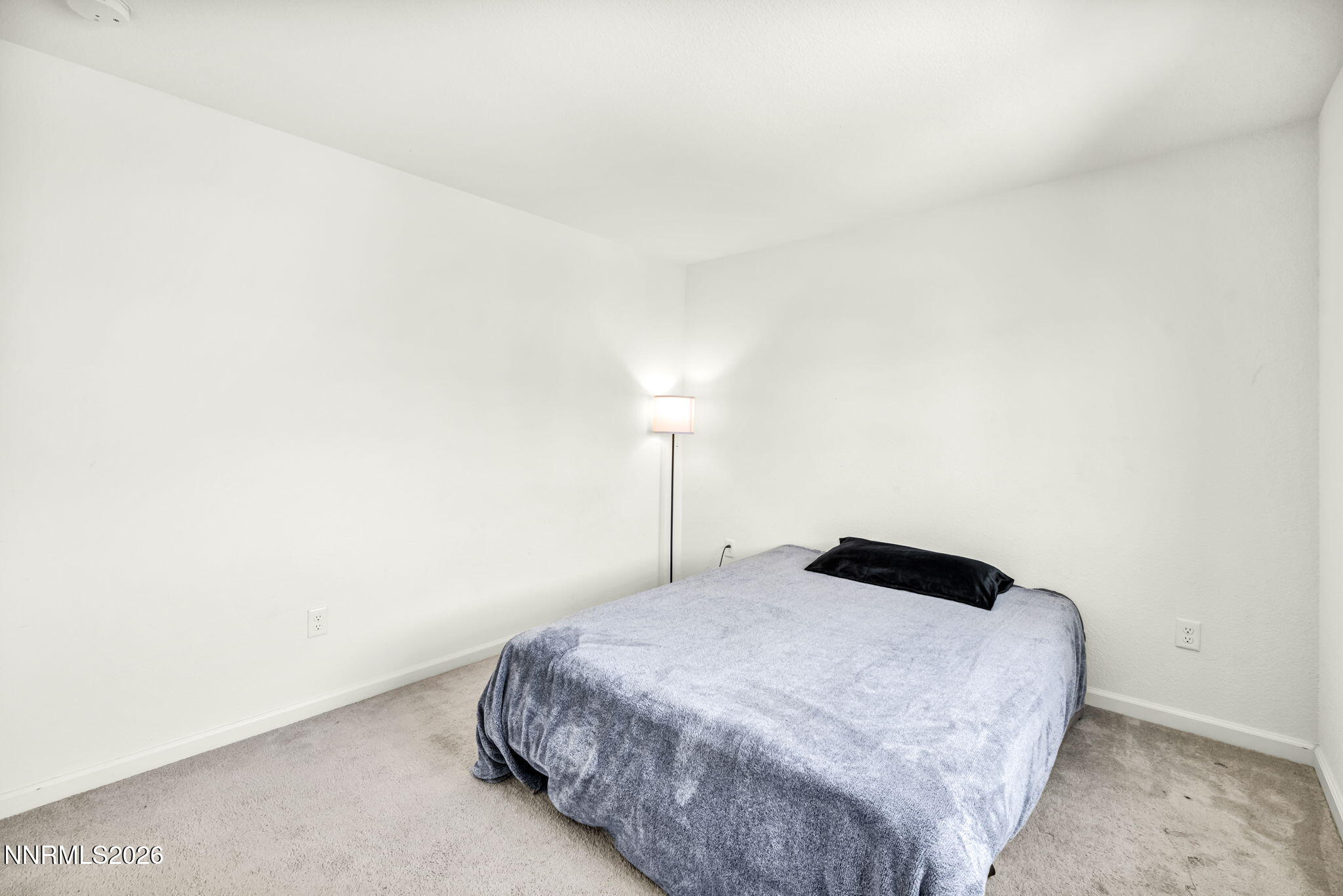 8982 Wolf River Drive Reno, NV 89506 - Photo 33 of 65 a bedroom with a bed and a night stand