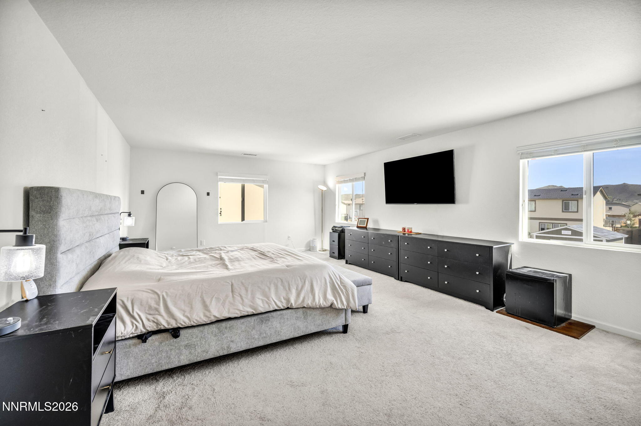 8982 Wolf River Drive Reno, NV 89506 - Photo 36 of 65 a bedroom with a bed and a flat screen tv