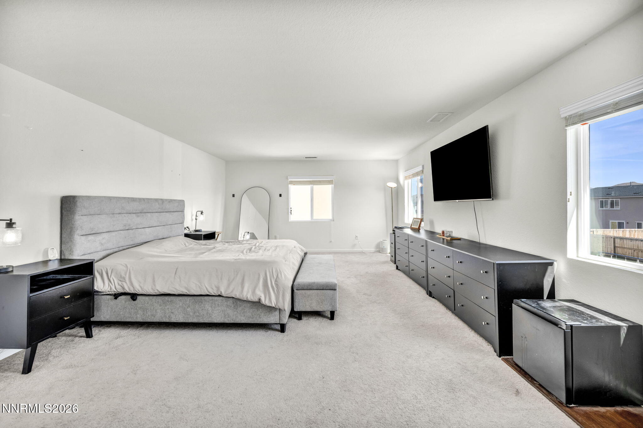 8982 Wolf River Drive Reno, NV 89506 - Photo 37 of 65 a spacious bedroom with a bed and a flat screen tv