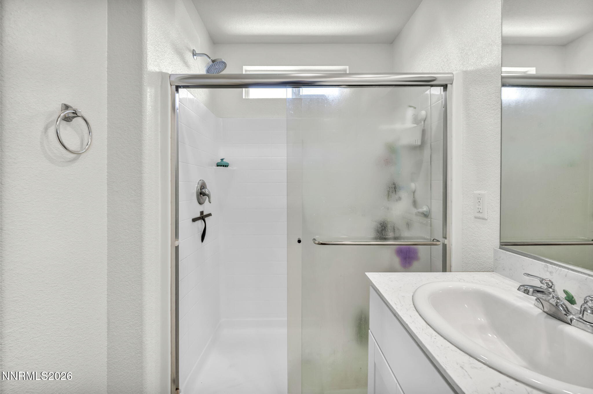 8982 Wolf River Drive Reno, NV 89506 - Photo 43 of 65 a bathroom with a shower sink vanity and mirror
