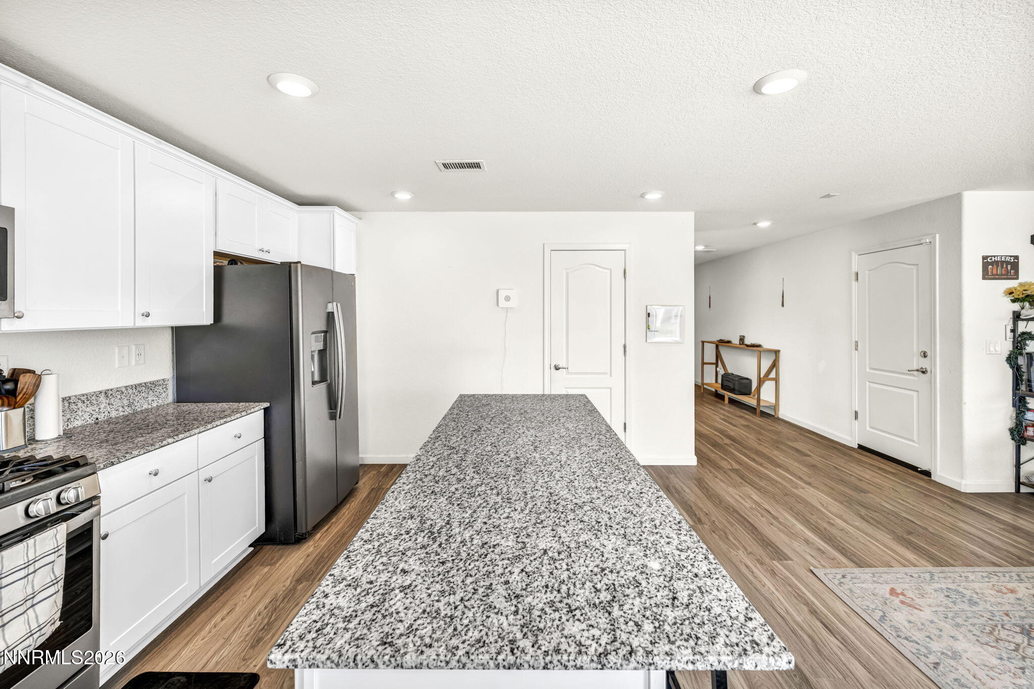 8982 Wolf River Drive Reno, NV 89506 - Photo 9 of 65 a large white kitchen with a stove and refrigerator