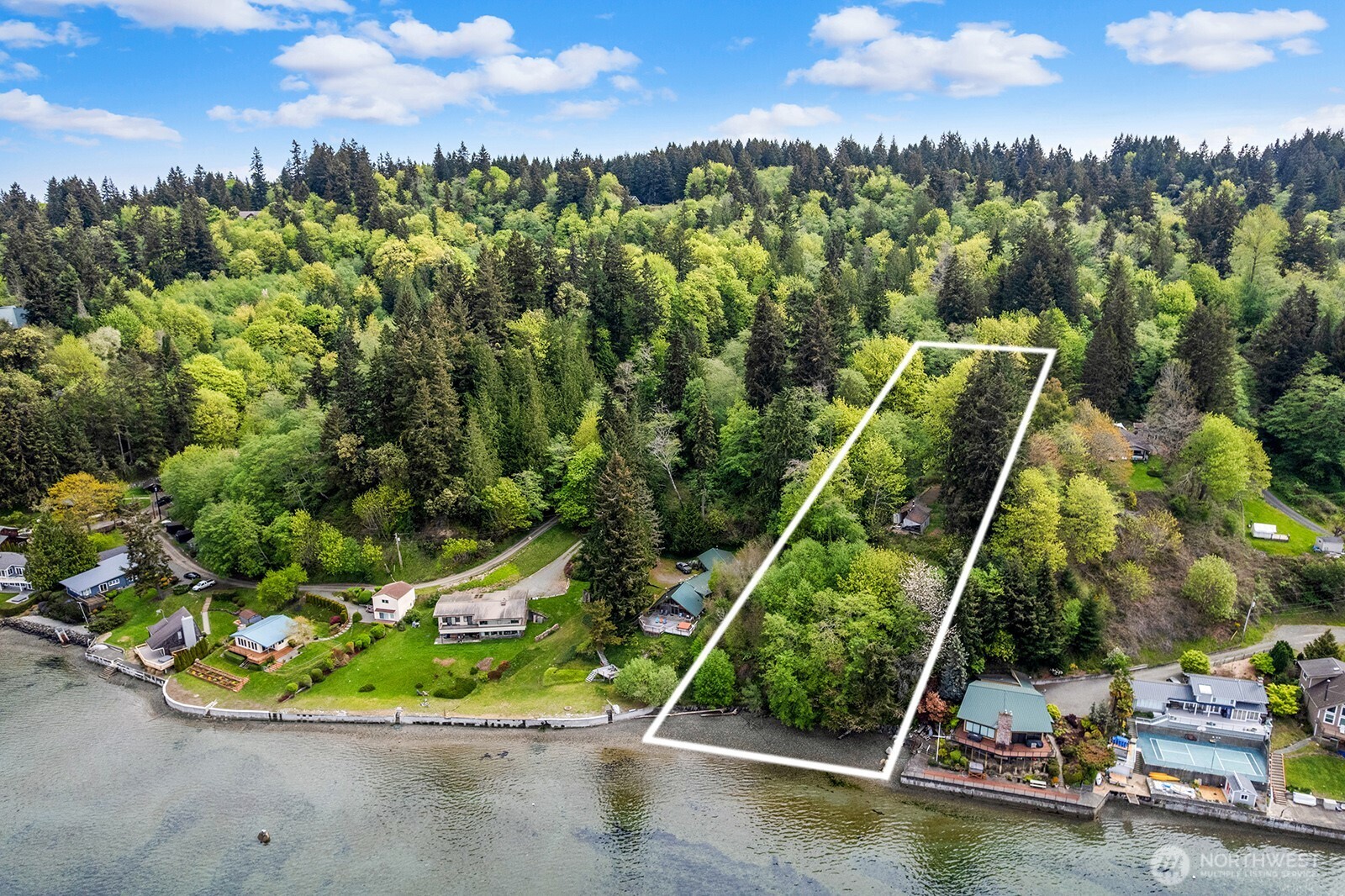 13843 Southwest 248th Street Vashon, WA 98070 - Photo 25 of 26 a view of a lake with a house in the background