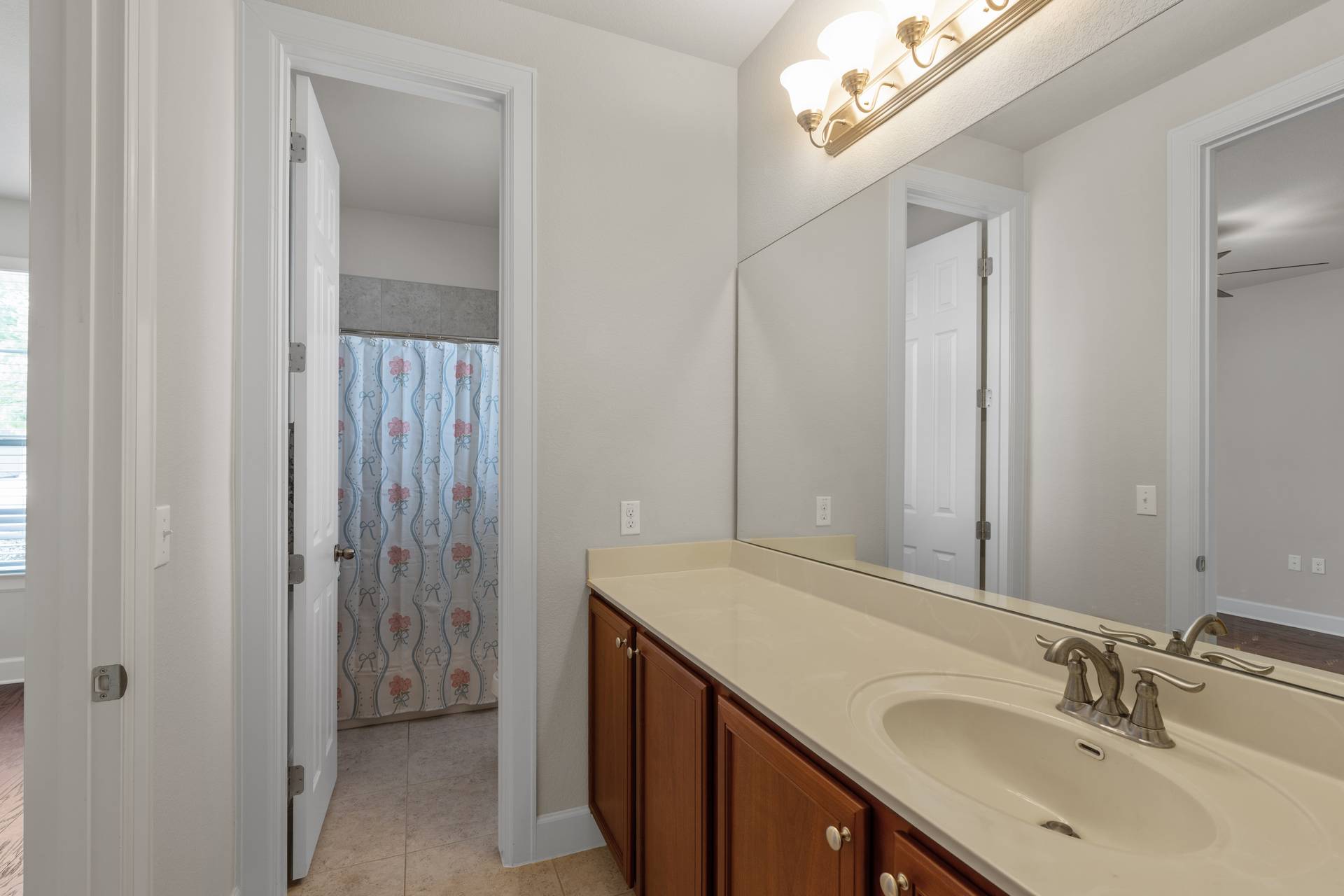 3516 Venezia View Leander, TX 78641 - Photo 15 of 40 Bathroom with a shower with curtain, vanity, and light tile patterned floors