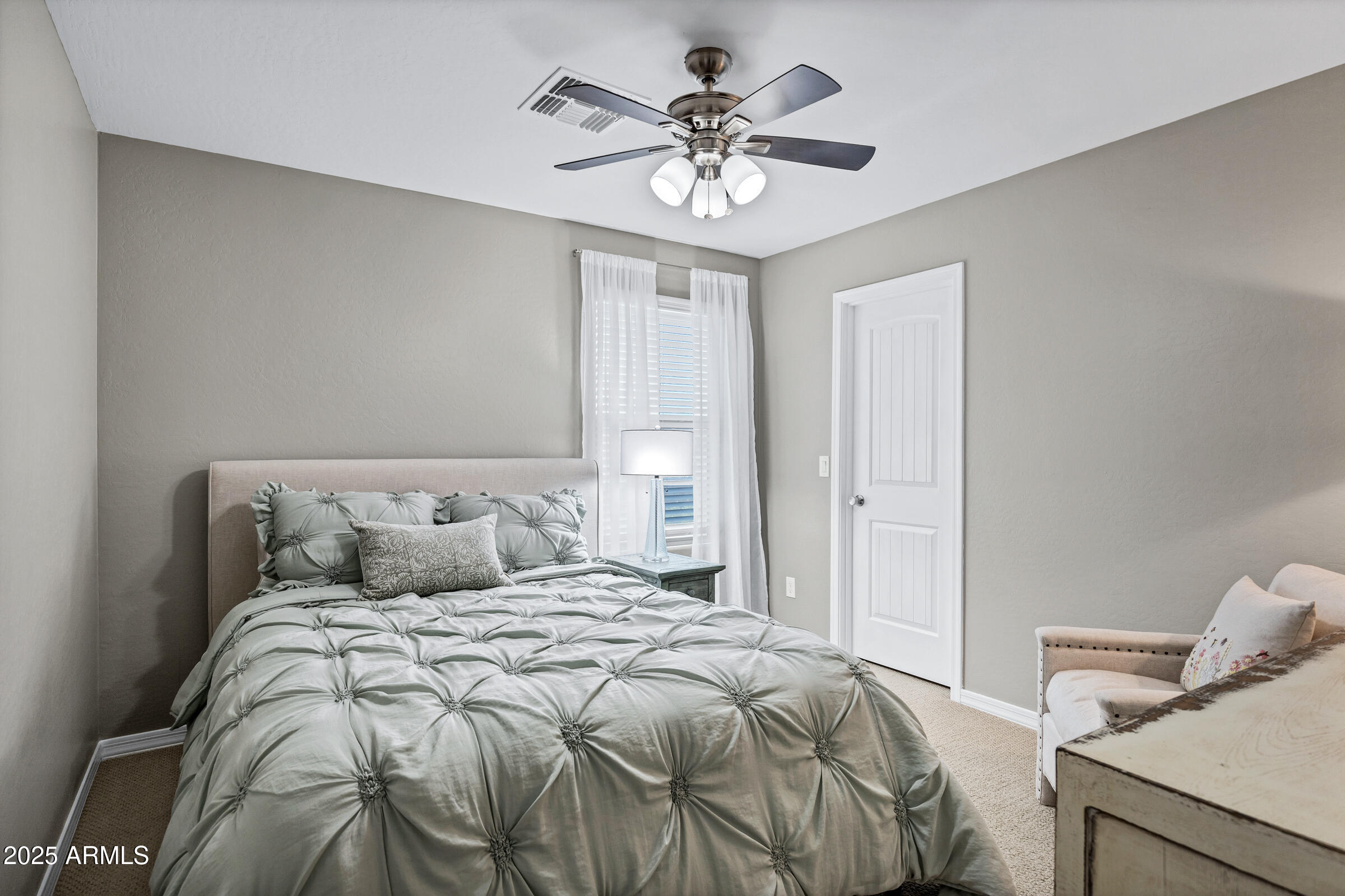41311 West Elm Drive Maricopa, AZ 85138 - Photo 14 of 25 a bedroom with a bed and a ceiling fan