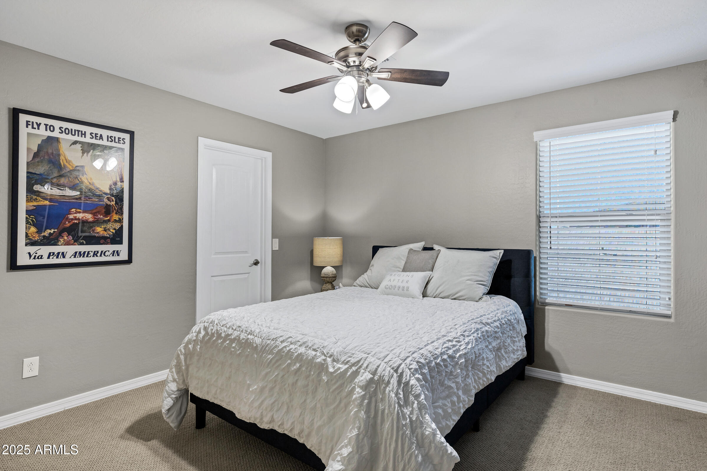 41311 West Elm Drive Maricopa, AZ 85138 - Photo 15 of 25 a bedroom with a bed and a chandelier