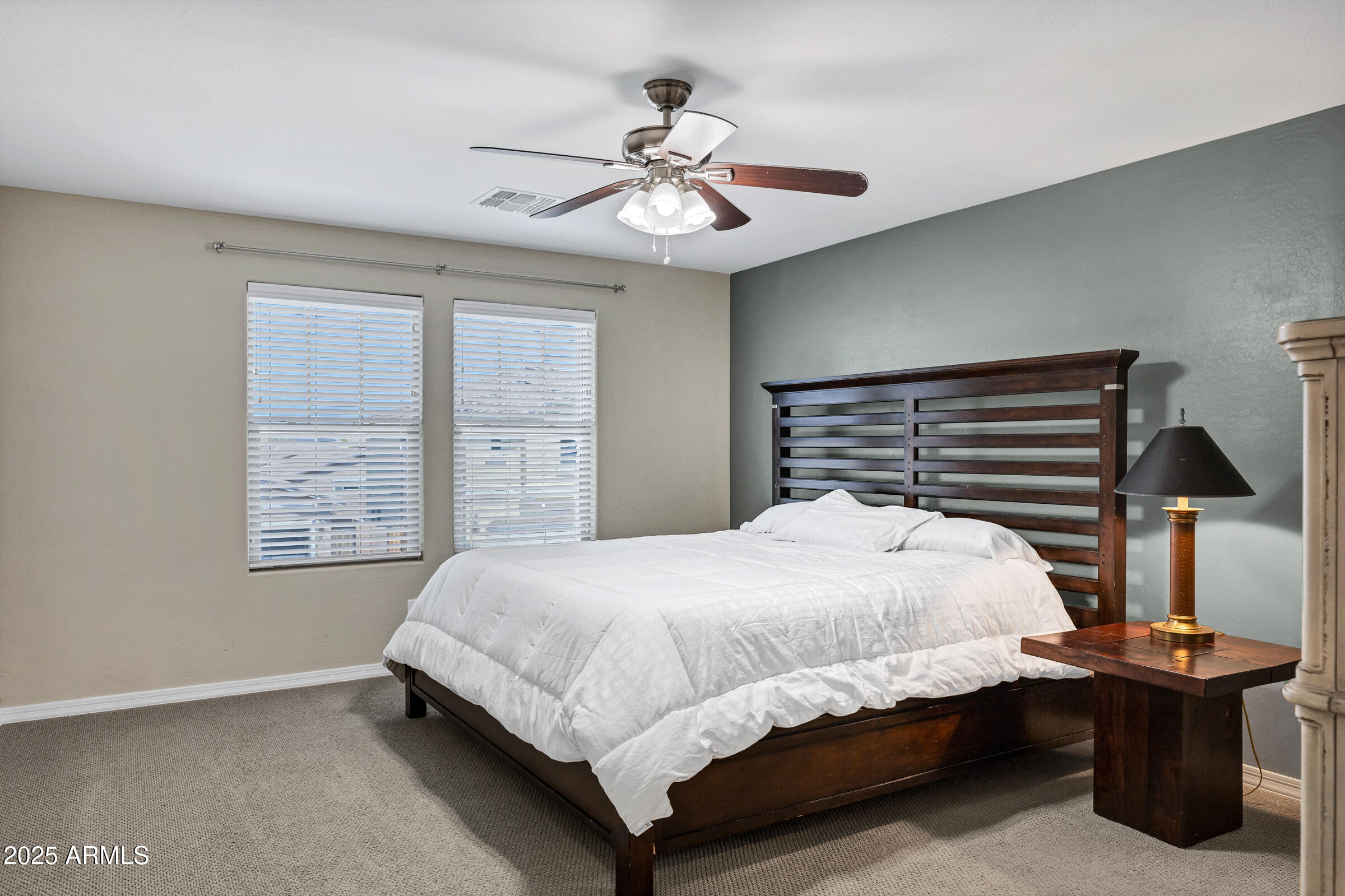 41311 West Elm Drive Maricopa, AZ 85138 - Photo 18 of 25 a bedroom with a bed and a chandelier