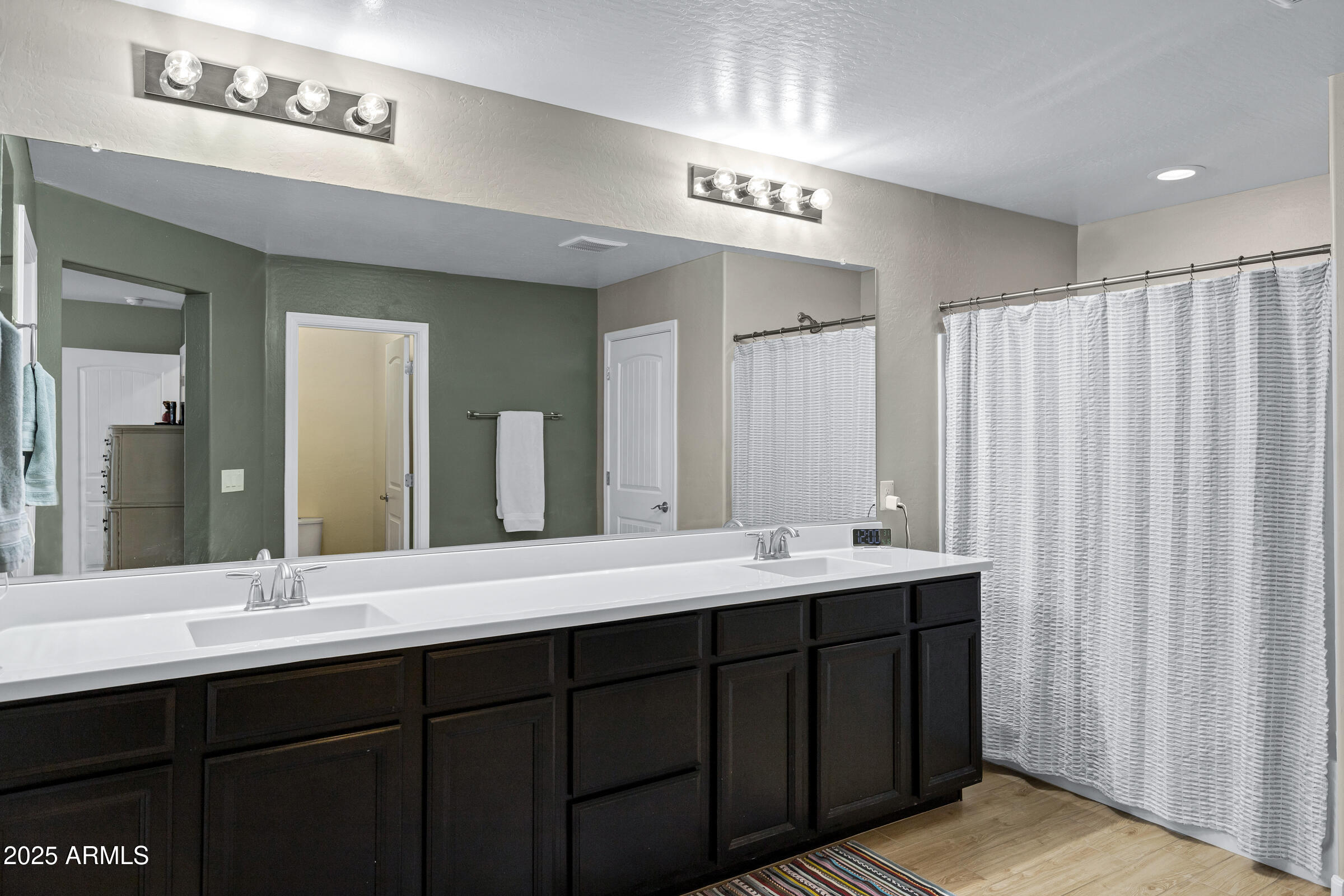 41311 West Elm Drive Maricopa, AZ 85138 - Photo 19 of 25 a bathroom with a double vanity sink and a mirror