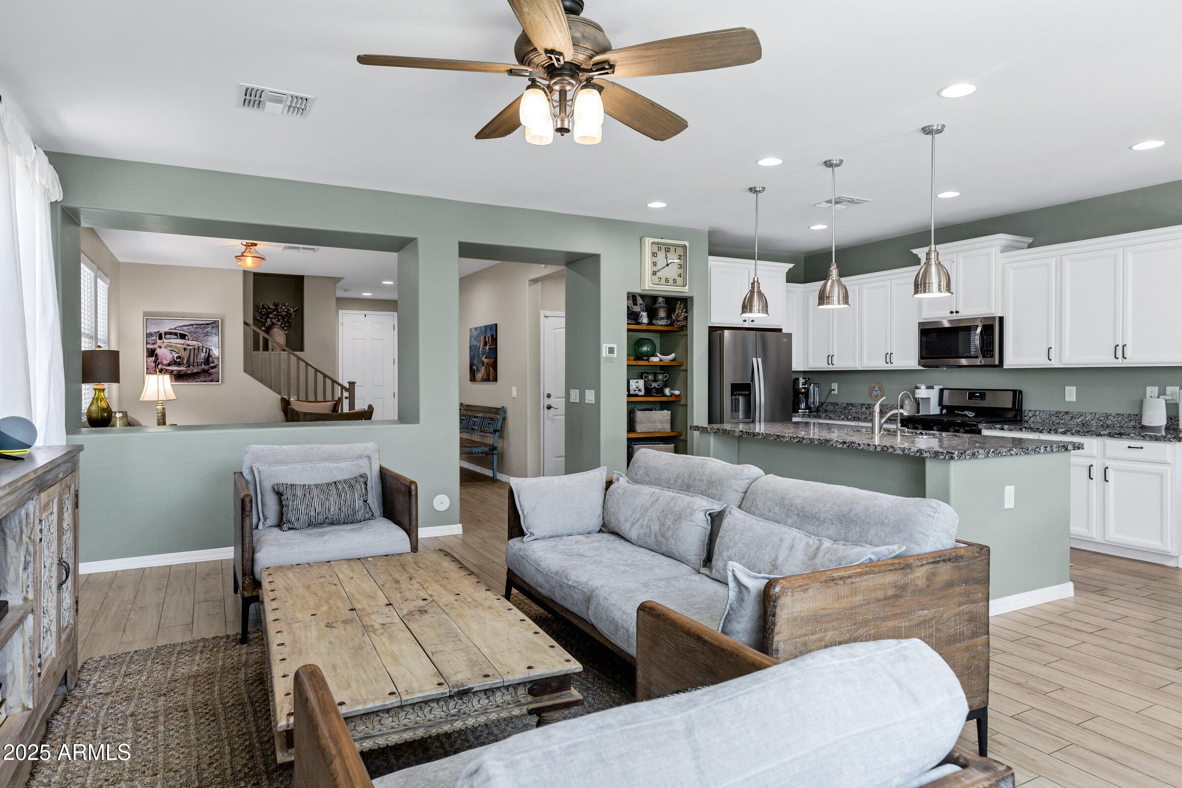 41311 West Elm Drive Maricopa, AZ 85138 - Photo 4 of 25 a living room with furniture kitchen view and a chandelier