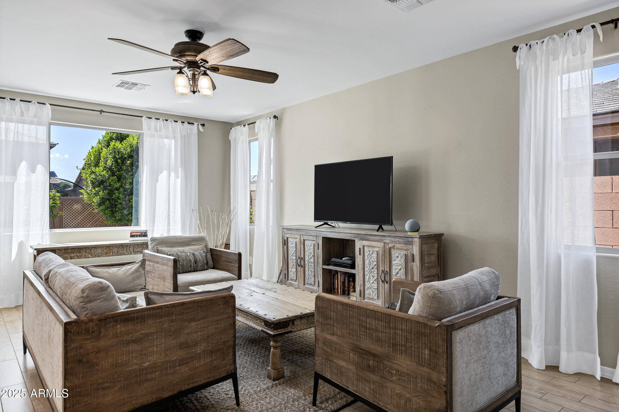 41311 West Elm Drive Maricopa, AZ 85138 - Photo 5 of 25 a living room with furniture and a flat screen tv