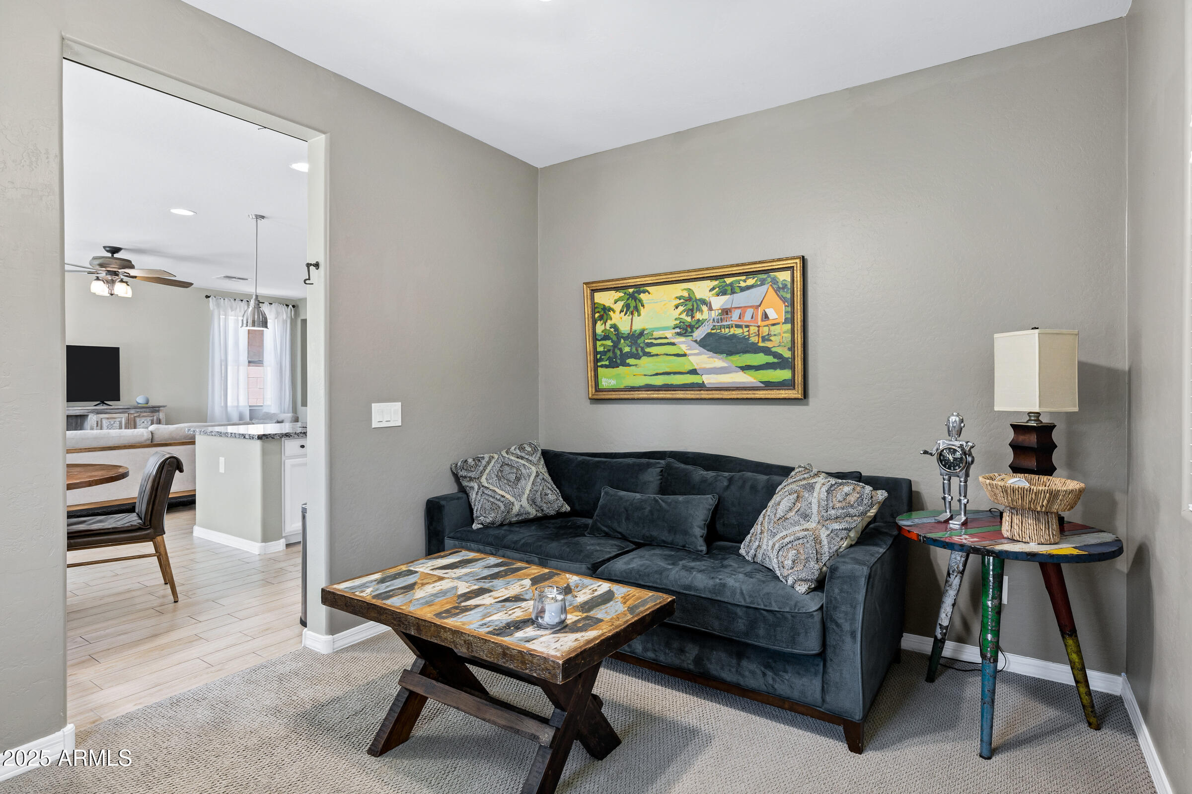 41311 West Elm Drive Maricopa, AZ 85138 - Photo 9 of 25 a living room with furniture and a dining table with kitchen view