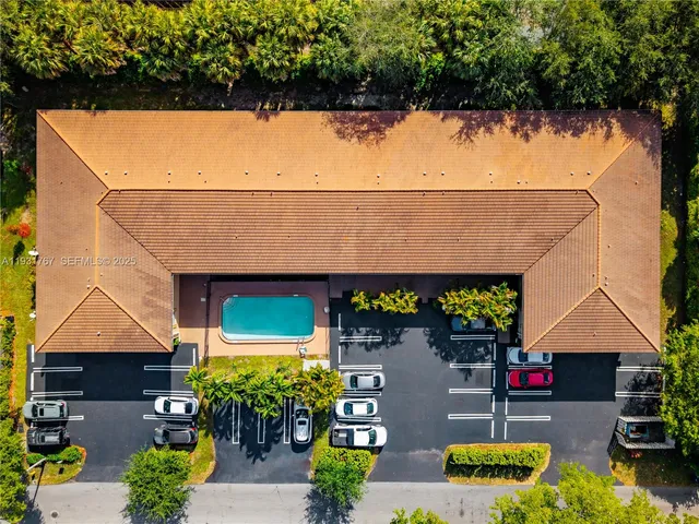an outdoor space with seating area and trees in the background