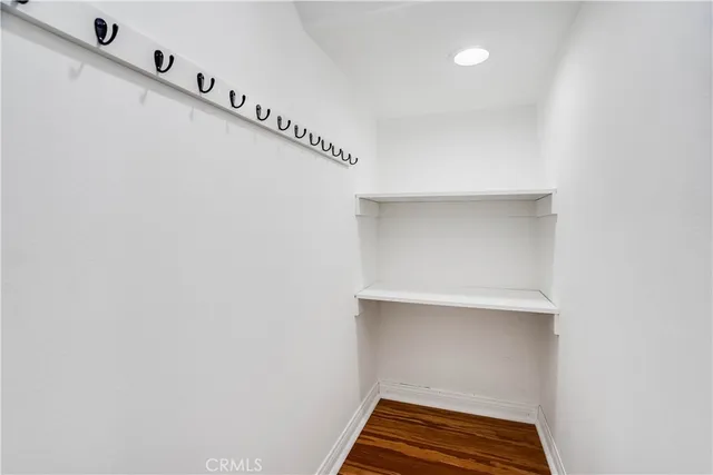 a view of room with stairs and wooden floor