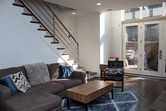 a view of a living room and a floor to ceiling window