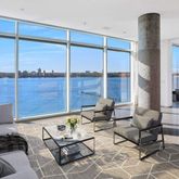 a living room with furniture and a floor to ceiling window