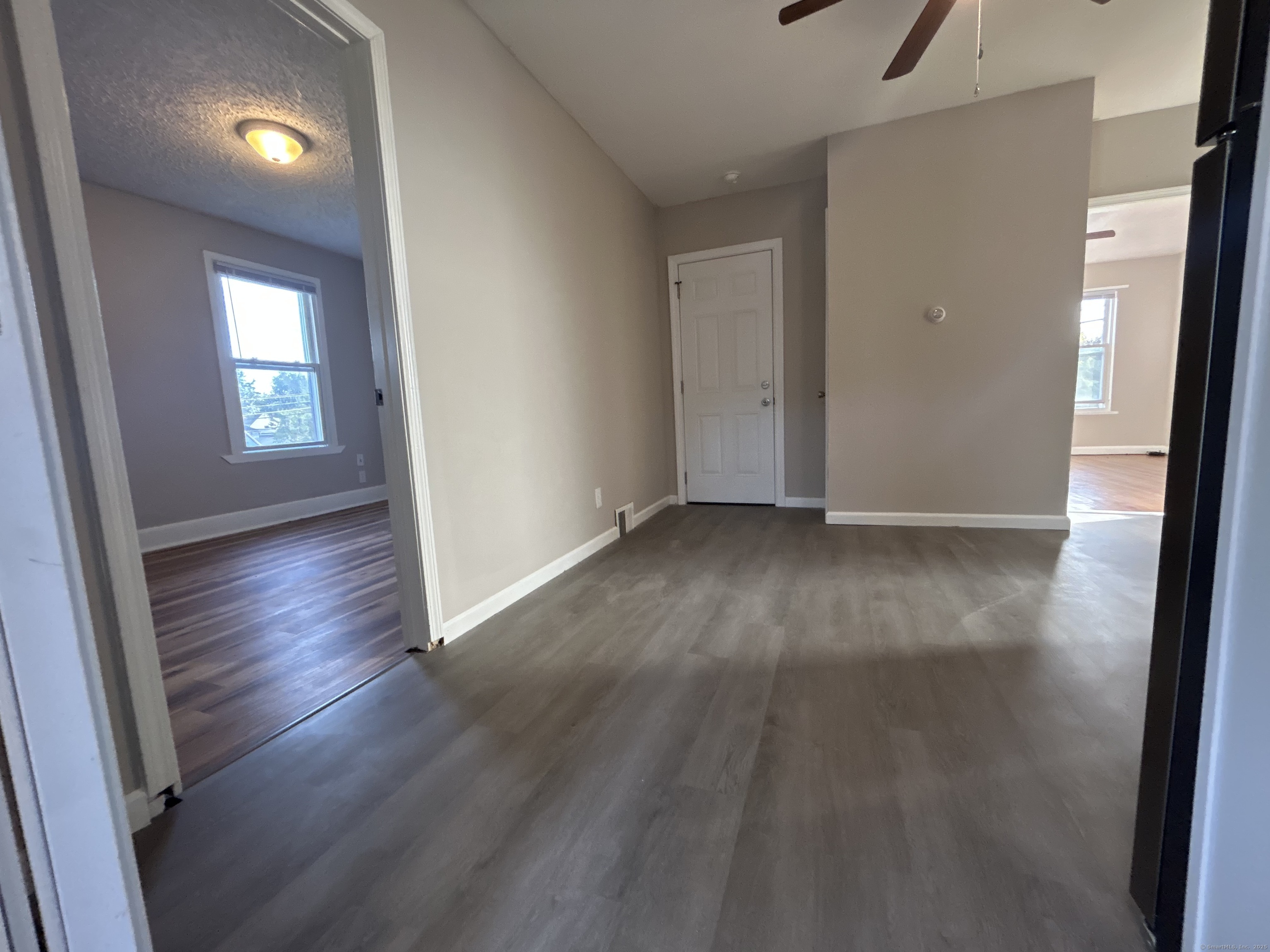 120 South End Road New Haven, CT 06512 - Photo 3 of 14 an empty room with wooden floor and windows