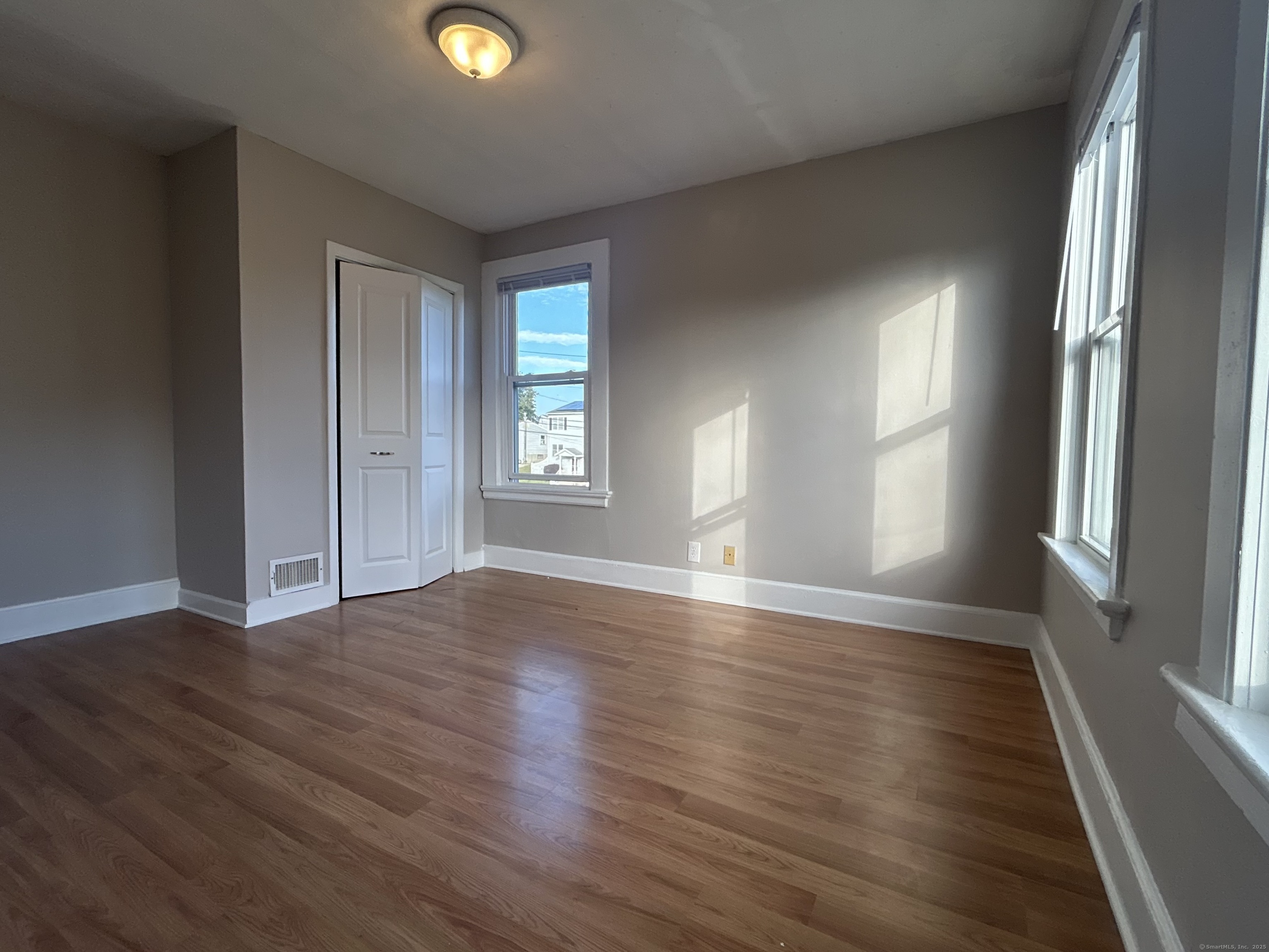 120 South End Road New Haven, CT 06512 - Photo 6 of 14 an empty room with wooden floor and windows