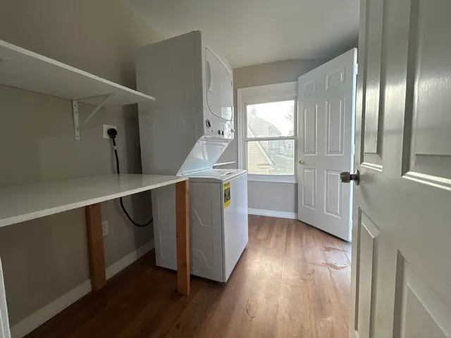 a hallway with wooden floors and cabinet
