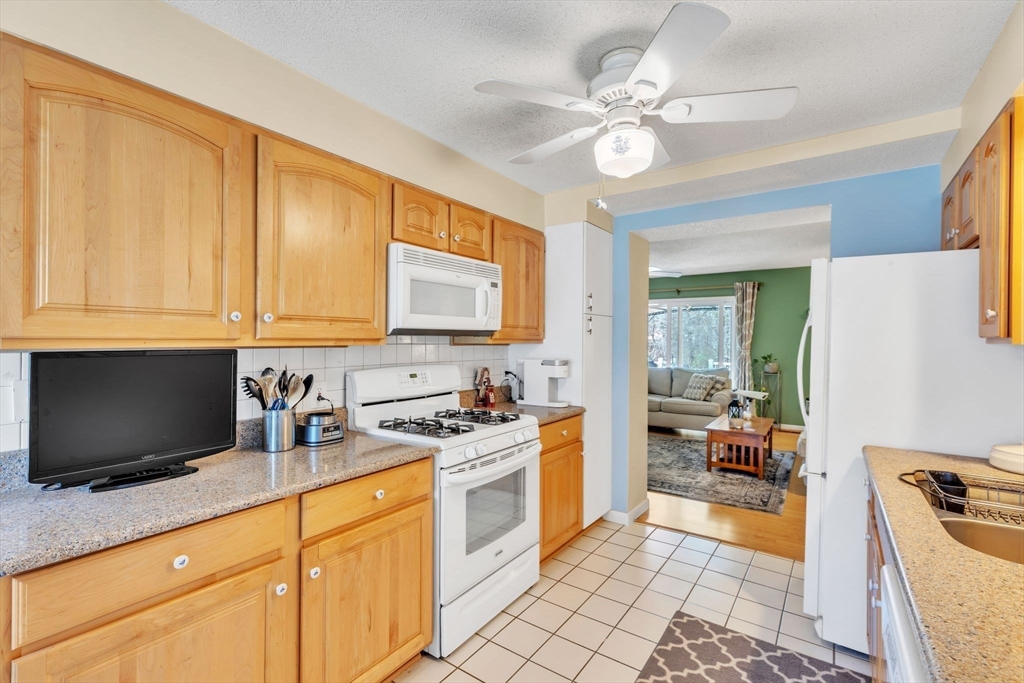 610 County Road, Unit 2 Holyoke, MA 01040 - Photo 11 of 42 a kitchen with a stove a sink and a microwave
