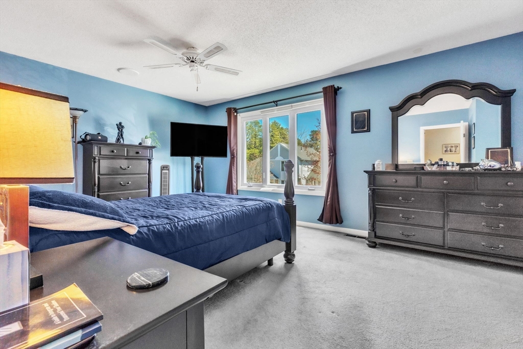 610 County Road, Unit 2 Holyoke, MA 01040 - Photo 18 of 42 a bedroom with a bed and a chandelier