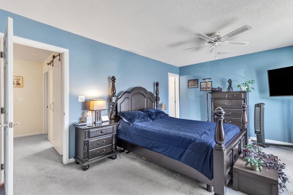 610 County Road, Unit 2 Holyoke, MA 01040 - Photo 20 of 42 a bedroom with a bed and a flat tv screen on dresser