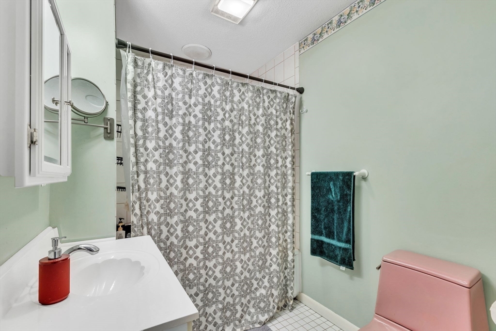 610 County Road, Unit 2 Holyoke, MA 01040 - Photo 26 of 42 a bathroom with a shower curtain and a sink