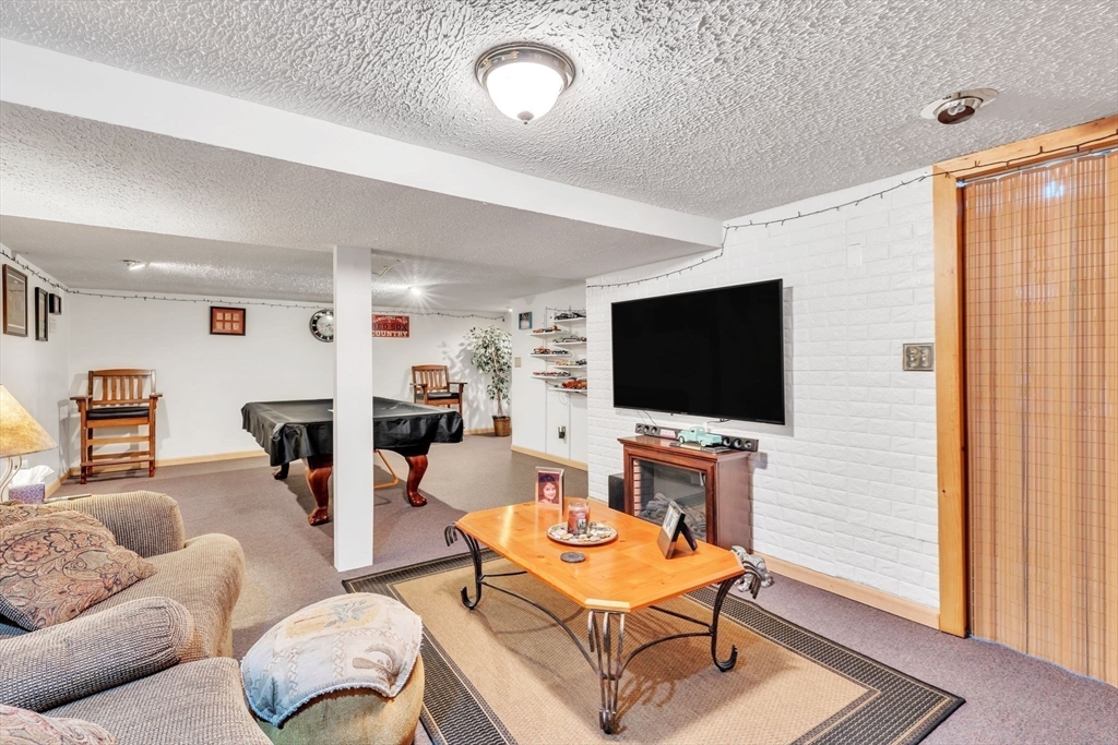 610 County Road, Unit 2 Holyoke, MA 01040 - Photo 27 of 42 a living room with furniture and a flat screen tv