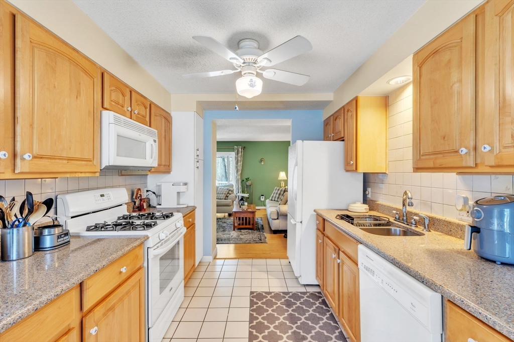 610 County Road, Unit 2 Holyoke, MA 01040 - Photo 9 of 42 a kitchen with stainless steel appliances granite countertop a sink a stove cabinets counter space and a window