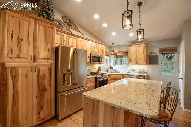 a kitchen with refrigerator a stove and cabinets