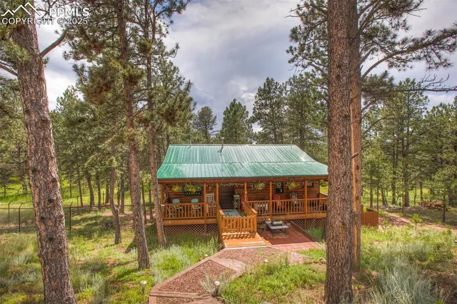 a view of a house with backyard porch and sitting area