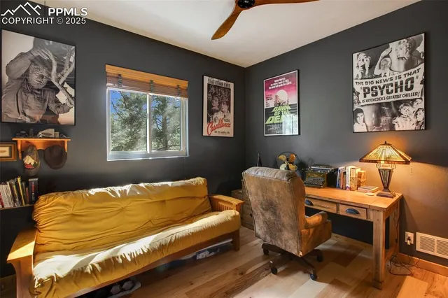 a bed sitting in a bedroom next to a window