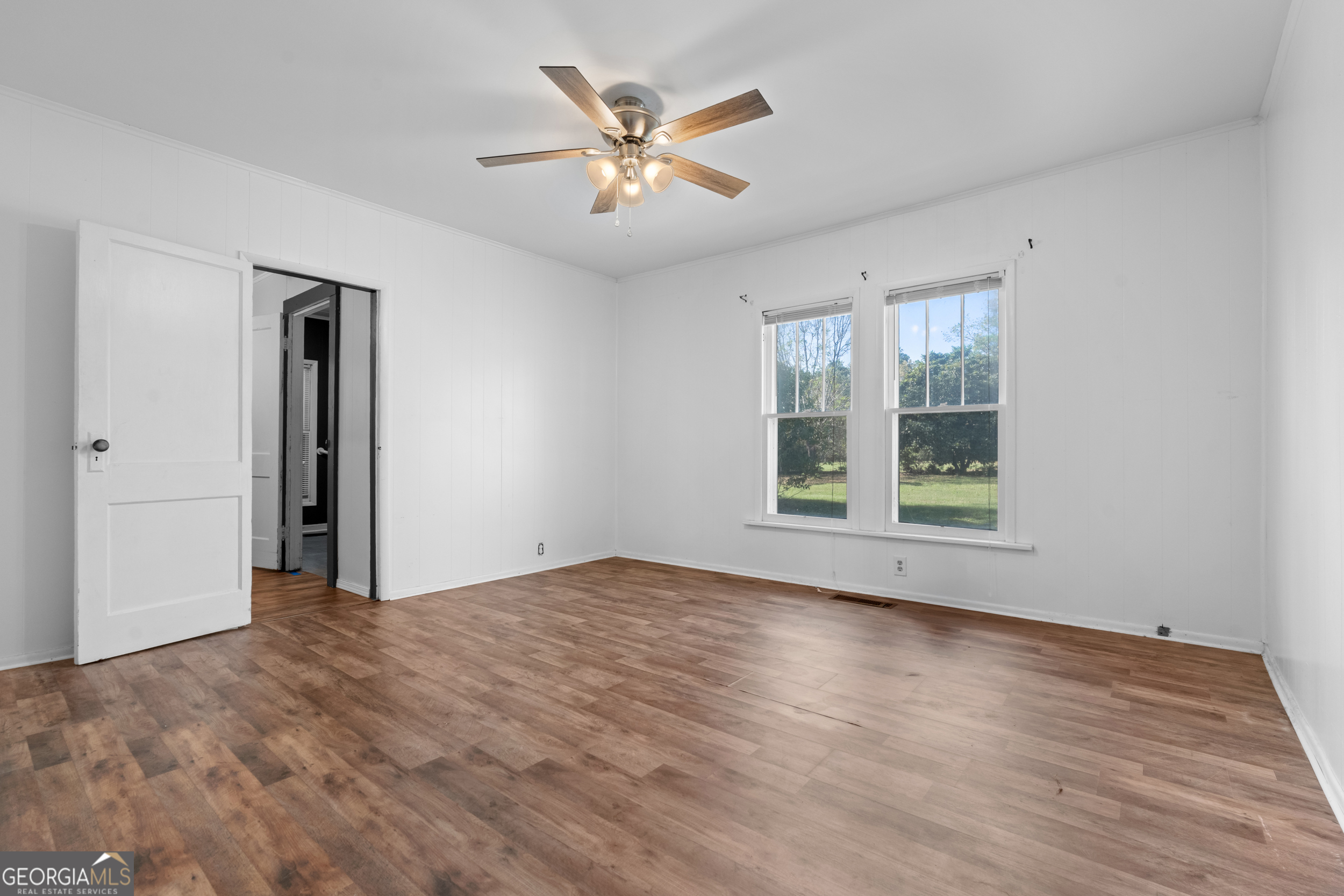 2 Finch Street Portal, GA 30450 - Photo 12 of 23 a view of an empty room with window and wooden floor