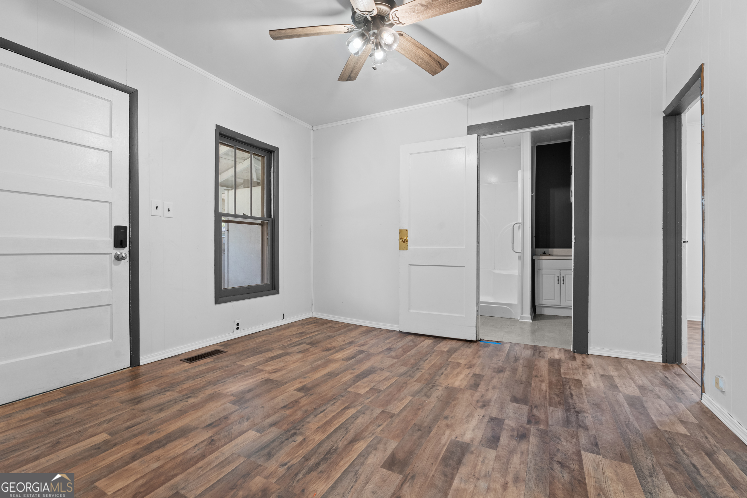 2 Finch Street Portal, GA 30450 - Photo 14 of 23 a view of an empty room with wooden floor and a ceiling fan